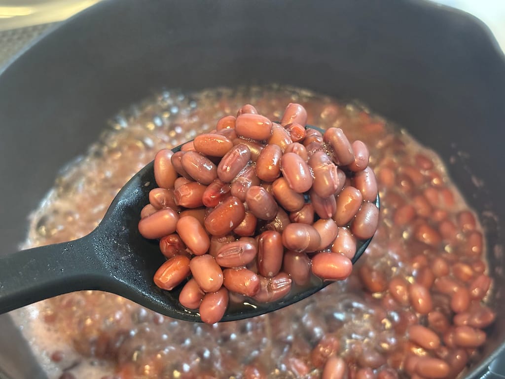 バーミキュラ雪平鍋で煮た小豆を黒いお玉ですくい上げたアップ