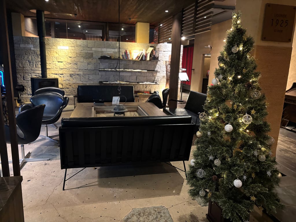 ツリーが飾られたラウンジ。吉田屋ラウンジに飾られたクリスマスツリーと黒革ソファ。季節感あふれる11月の館内デコレーション。